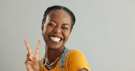 Portrait, peace sign and black woman with smile, support and motivation on grey studio background. African person, face and model with hand gesture, v symbol and excited with icon, feedback or review