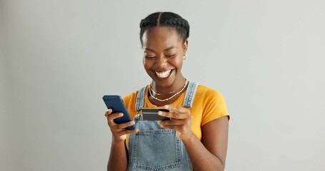 African woman, credit card and phone in studio with smile for deal, discount and fintech by white...