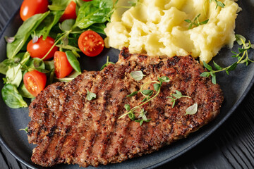 grilled pork steak with mashed potato and salad