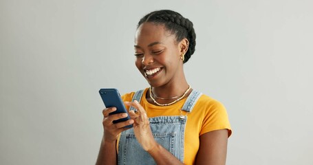 African woman, phone and texting in studio with smile, reading or thinking for contact by white...