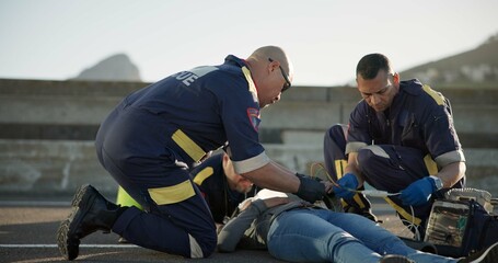 Paramedic, rescue and team with patient, outdoor and EKG to check heart, service and helping of...