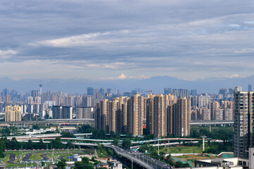 The downtown skyline in the morning  with the highest peak of Mount Siguniang background in Chengdu, Sichuan province, China, which is called "The park city at the foot of the snow-capped mountain".