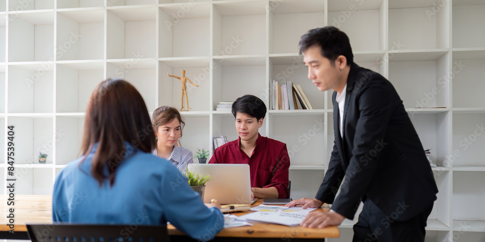 Aufkleber diverse business team engaged in analysis and discuss in modern office setting with open shelving ba