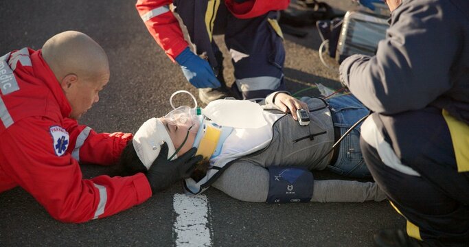 Paramedic, oxygen and outdoor with patient, healthcare and rescue of breathing, service or ambulance for person. EKG monitor, accident or injury on street, pulse oximeter and EMS with victim in USA