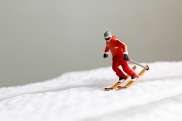 A miniature figurine of a skier dressed in vibrant winter gear. This image is perfect for themes...