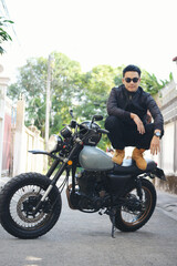 Asian man motorbike in black leather jacket travel rider trip. Handsome Men wear sunglass outdoor lifestyle freedom rider. Men trendy hipster cool person. Young asian man hobby ride with motor bike
