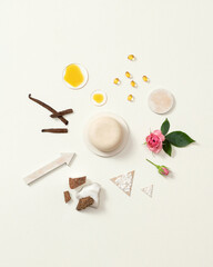 Round white solid shampoo with natural ingredients. Soap with coconut and rose. Circular composition of dry shampoo ingredients. Hair care products. Advertising. White background. Copy space.