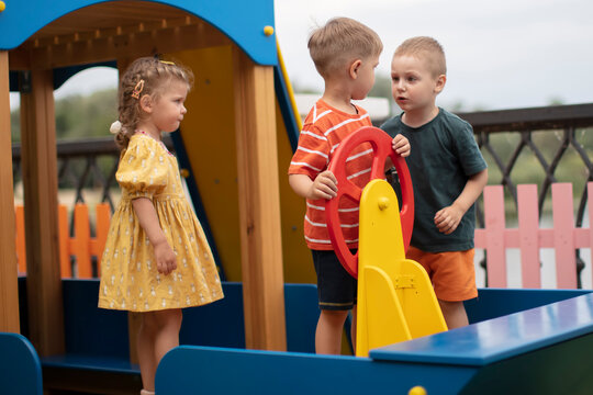 Conflict in young children. Three kids swear and argue in children's