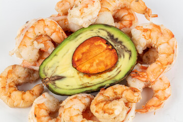 Avacado cut in half with boiled shrimp. Ingredients for an exotic salad.