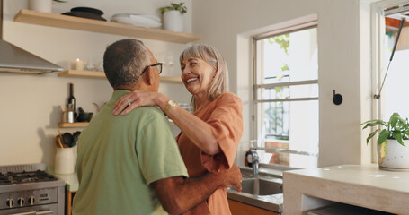 Senior couple, love and dancing in kitchen for retirement and healthy relationship with romance....