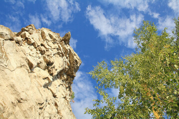 The rock of the mountain is called a camel, against the background of a blue sky, near the village of Shiryaevo, Samara region of Russia