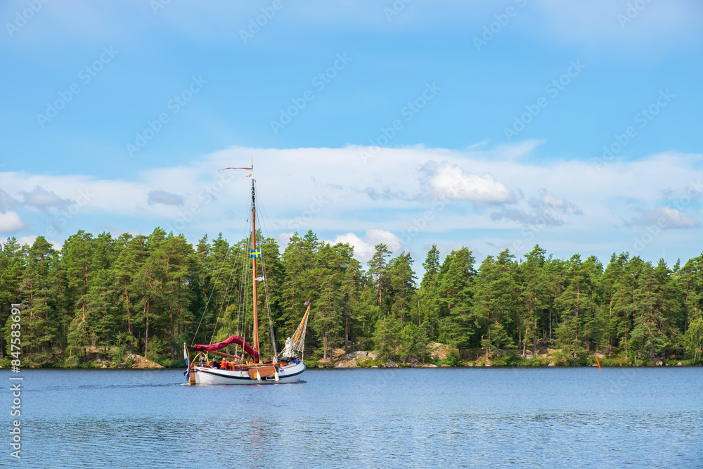 Canvas Prints Old sailboat on a lake in a beautiful forest landscape