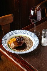 grilled beef tenderloin on a plate with side dish and sauce