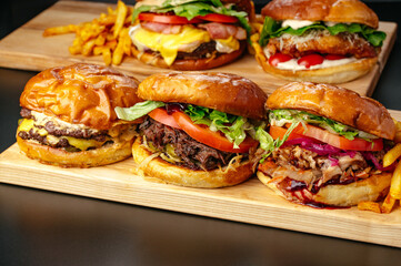 juicy big burgers on a wooden board