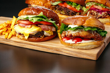 juicy big burgers on a wooden board