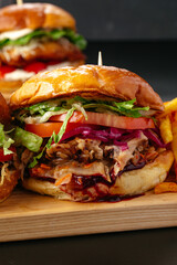 juicy big burgers on a wooden board