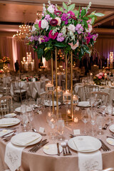 Elevated floral arrangement at candlelit wedding reception