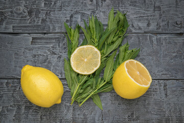 Fresh Lemons and Mint Leaves on Rustic Wooden Background