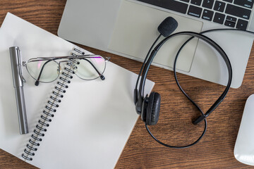 computer laptop and headphone on the table