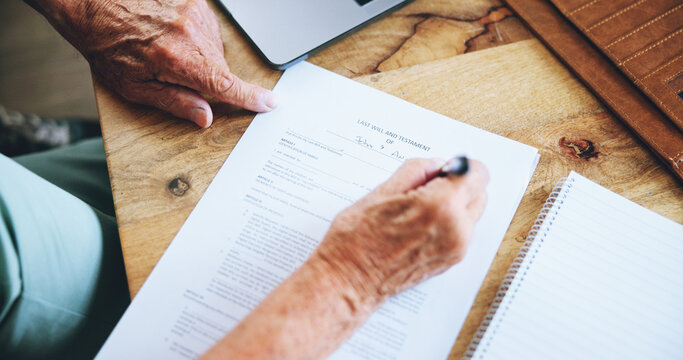 Hands, writing and document for will in home with information, reading and security for assets in death. Senior person, lawyer and signature for finance, money and payment for inheritance in house