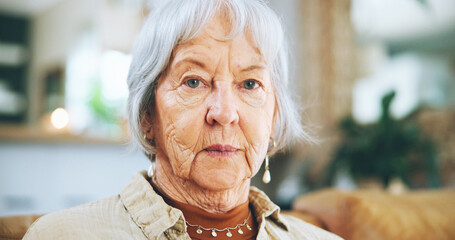 Senior, woman and serious portrait in home with nostalgia, lonely or depression on sofa in...