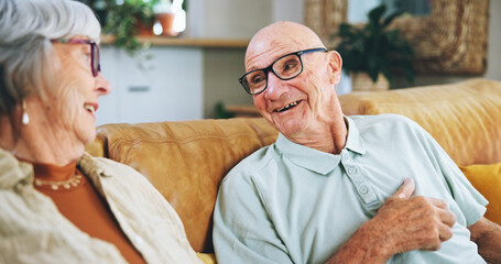Senior couple, talking and happy on sofa with memory, care and bonding with love in home living...