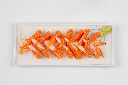 Crab sticks are placed on a plate and ready to serve.
