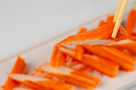 Crab sticks are placed on a plate and ready to serve.