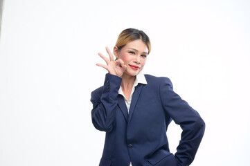 In a studio with a white backdrop, a poised transgender woman dons a tailored suit, striking confident poses, capturing the essence of professionalism and sophistication in various business settings.