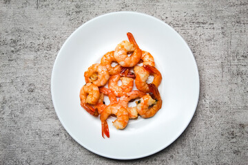 stir-fried shrimp dish in a white plate