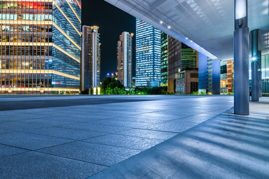 Fototapeta Empty square floors with modern city buildings at night in Shanghai