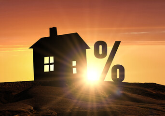 Percent sign and model of house on bright sunset background. House Mortgage Loan Or Credit. Real...