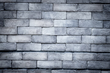 A gray brick wall with a white line running down the middle