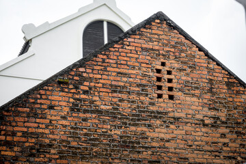 A brick building with a white roof