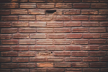 A brick wall with a few holes in it