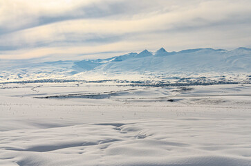 snowy Mount Aragats and Kasakh river valley scenic view from Yeghipatrush village (Aragatsotn province, Armenia) © ssmalomuzh
