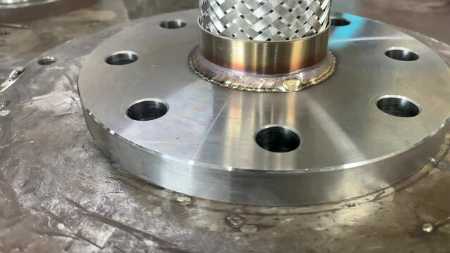 Welding seam on metal pipeline part close-up side view.