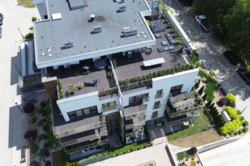 Modern apartment building with rooftop terraces and green gardens