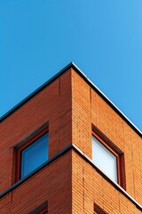 Red brick building on blue sky background, business center