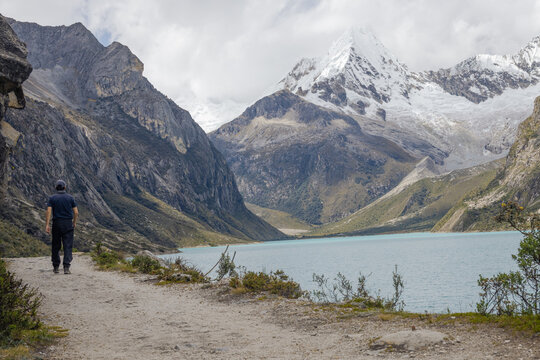 Hiker at Paron lake in the mountains Huascaran National Park