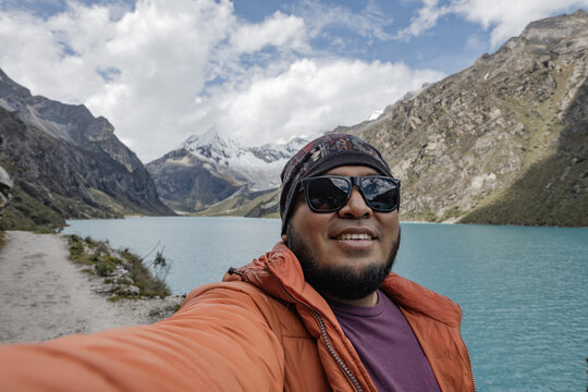 Man take a selfie with Paron lagoon in the mountains