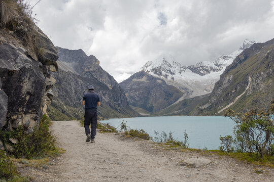 Hiker at Paron lake in the mountains Huascaran National Park