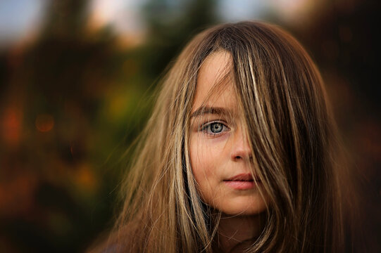 Up close portrait of beautiful young girl with green eyes blonde hair