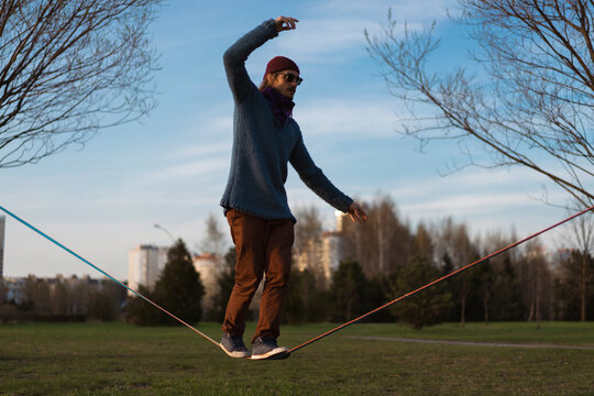 Young man balancing on slackline.