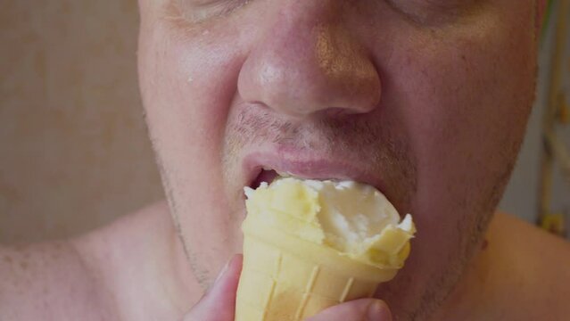A man eats ice cream with appetite. Close-up of a man's mouth chewing.