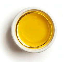 Top view of yellow liquid in a petri dish or glass with bubbles on a white background.