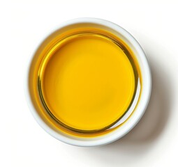 Top view of yellow liquid in a petri dish or glass with bubbles on a white background.