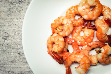 stir-fried shrimp dish in a white plate
