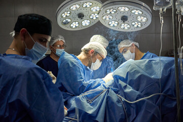 Surgeons Performing Surgery in Operating Room Under Bright Lights