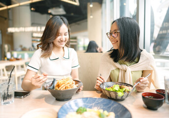 Happy two asian woman eating food at Japanese restaurant asia tasty from traditional culture together